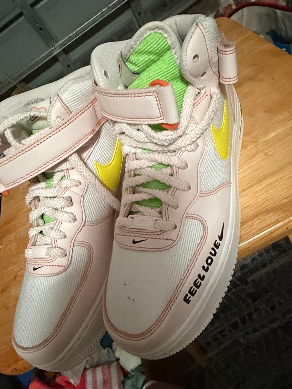 Nike Women’s Pink High-Top Sneakers with Yellow Swoosh